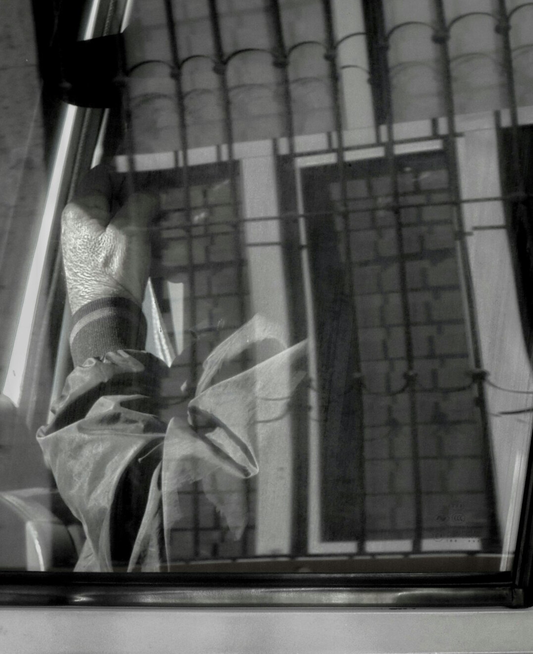 Close-up of hands writing notes in a notebook near a window