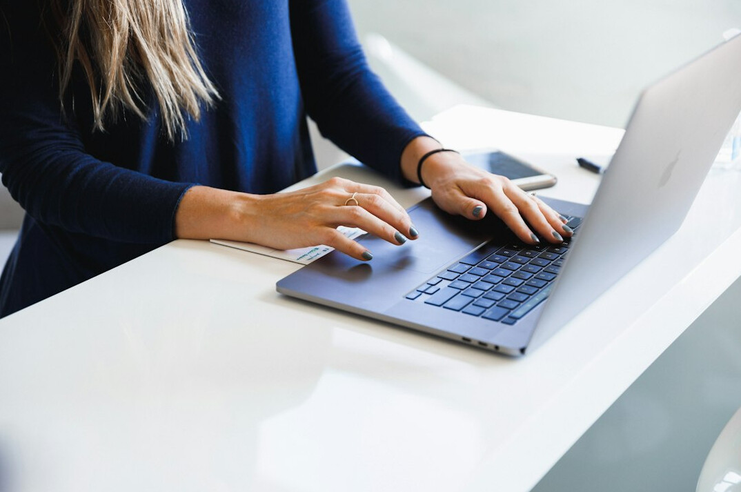 writer typing on laptop