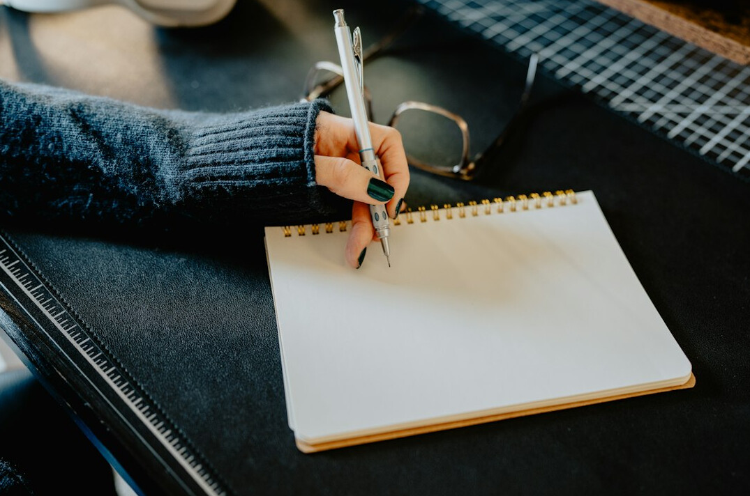 writer at desk with notebook